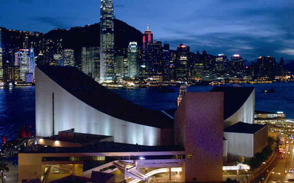 Hong Kong Cultural Centre with the night view of the Victoria Harbour as backdrop